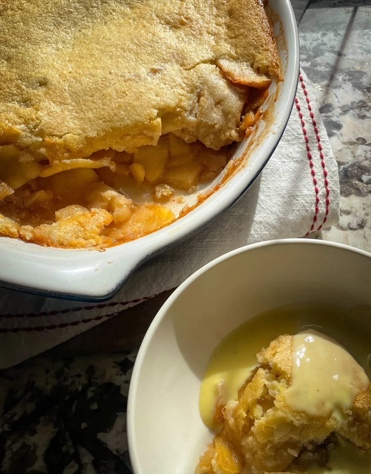 apple cobbler topped with vanilla custard