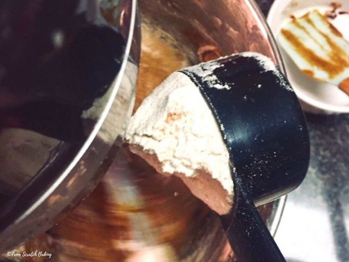 adding flour to mixer