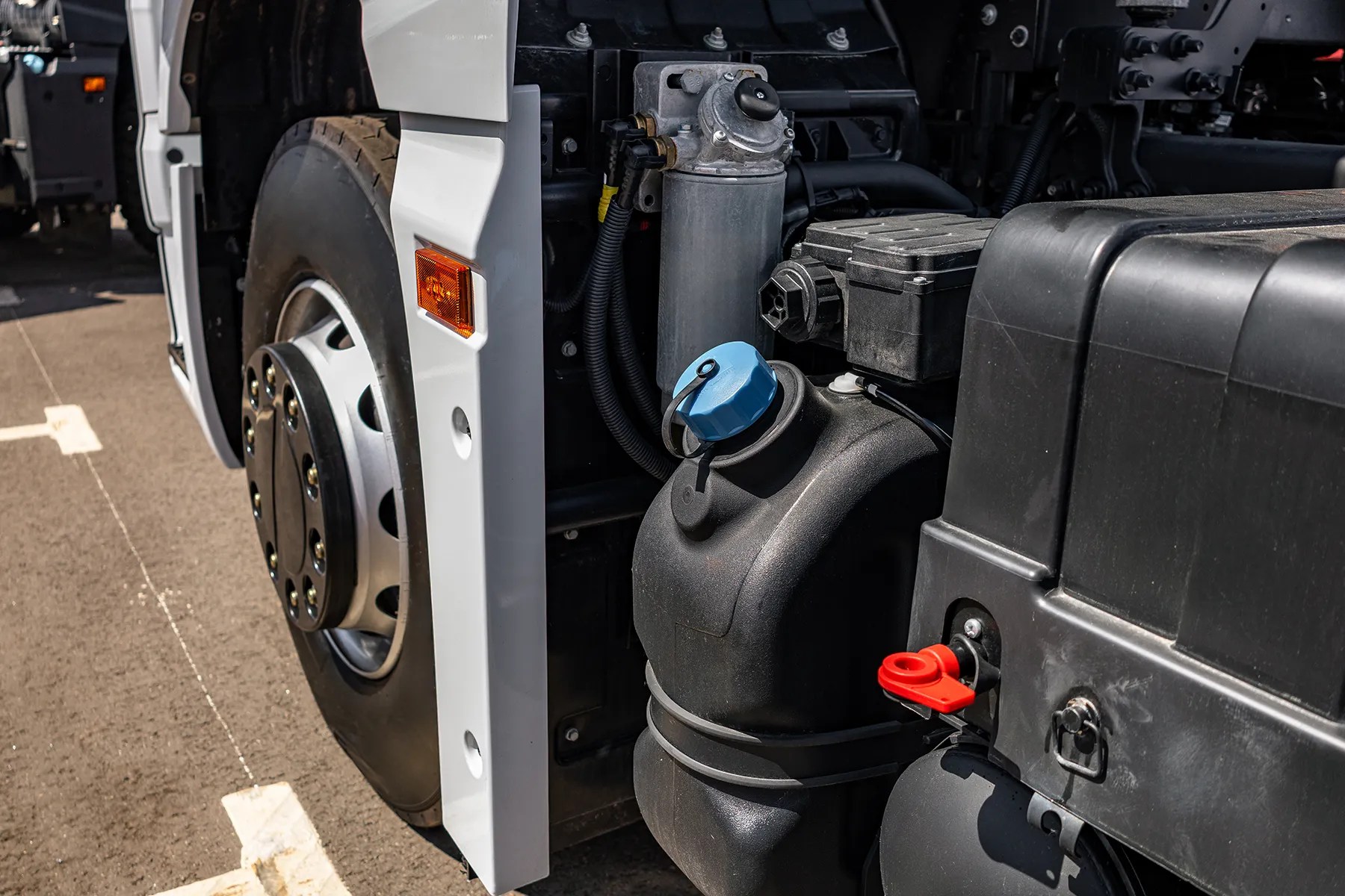 Blue DEF fill cap and fluid tank on a commercial truck