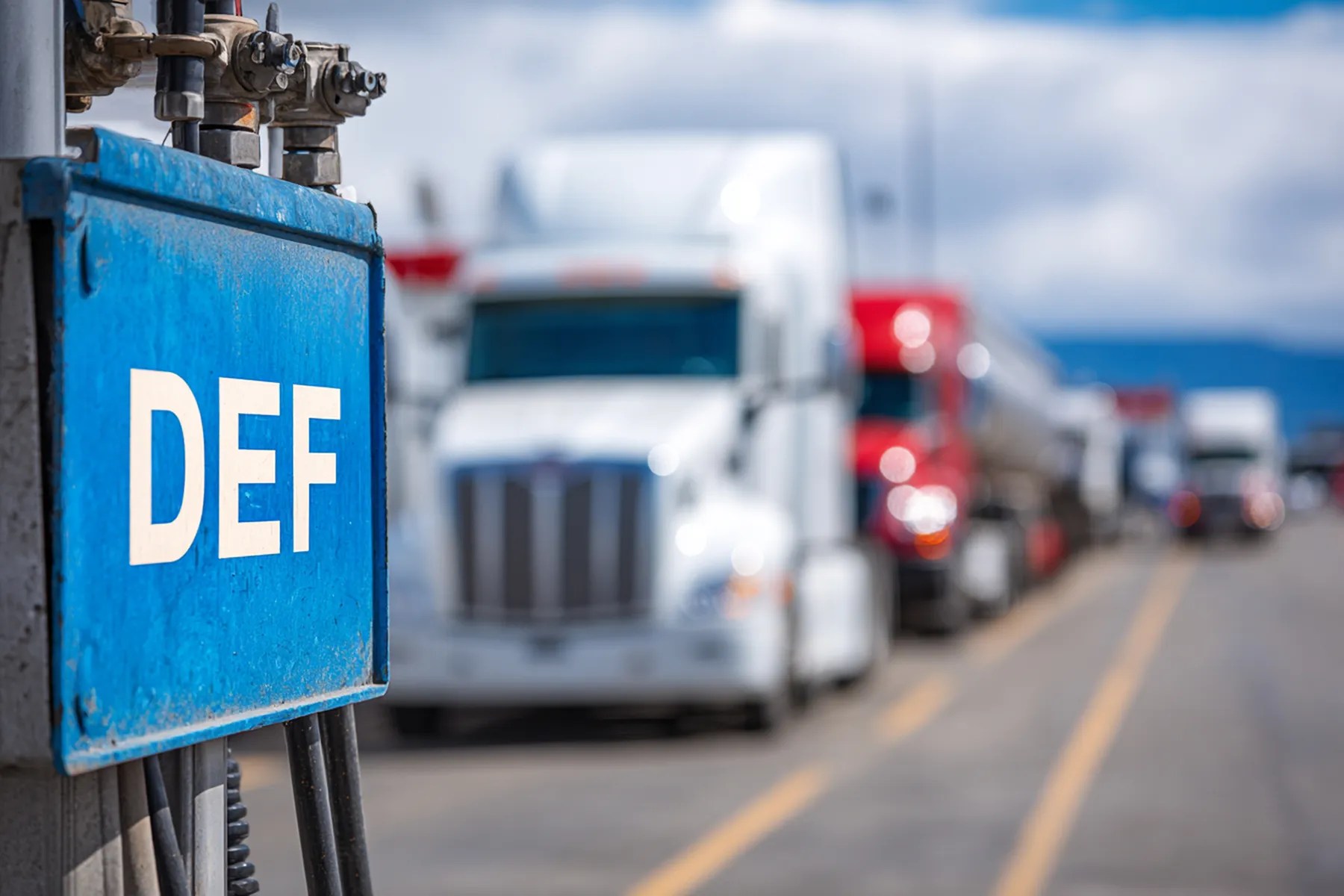 DEF dispensing equipment with commercial trucks lined up in the background