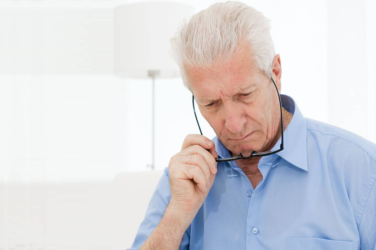 Man having difficulty reading