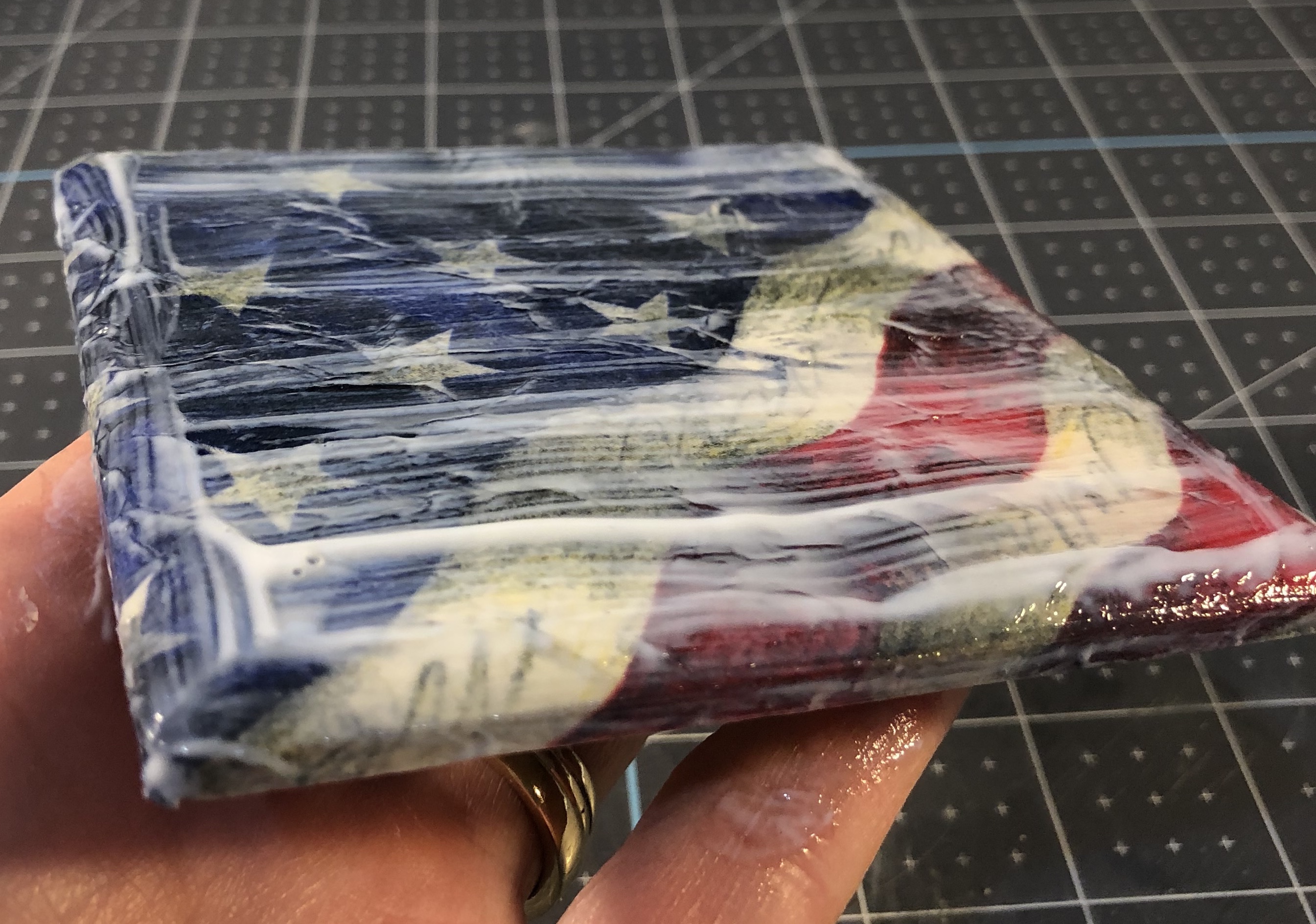 Mod Podge on flag napkin on tile ()