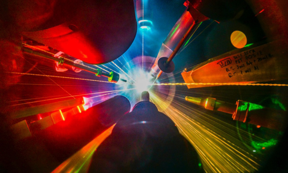 Close-up of multiple colored laser beams converging on a fusion target inside the University of Rochester's Laboratory for Laser Energetics.