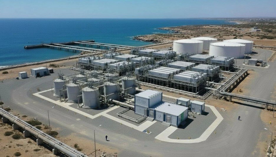 An aerial rendering of a coastal water desalination plant powered by the nT-Tao Tao Energy Box compact fusion system, illustrating on-site baseload power for critical water infrastructure.