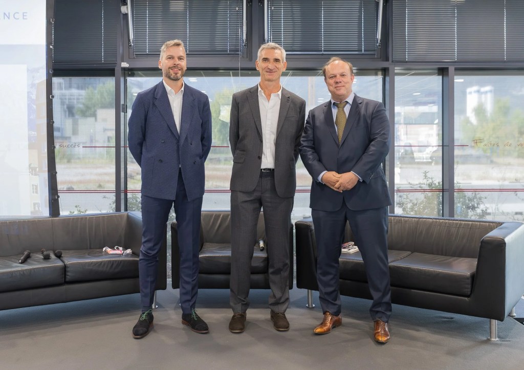Sam Guilaumé of Renaissance Fusion, Marco de Baar of DIFFER and Hans Priem of VDL Enabling Technologies Group stand together in a glass-walled venue. Their three organisations have signed an MoU to industrialise fusion in the Netherlands.