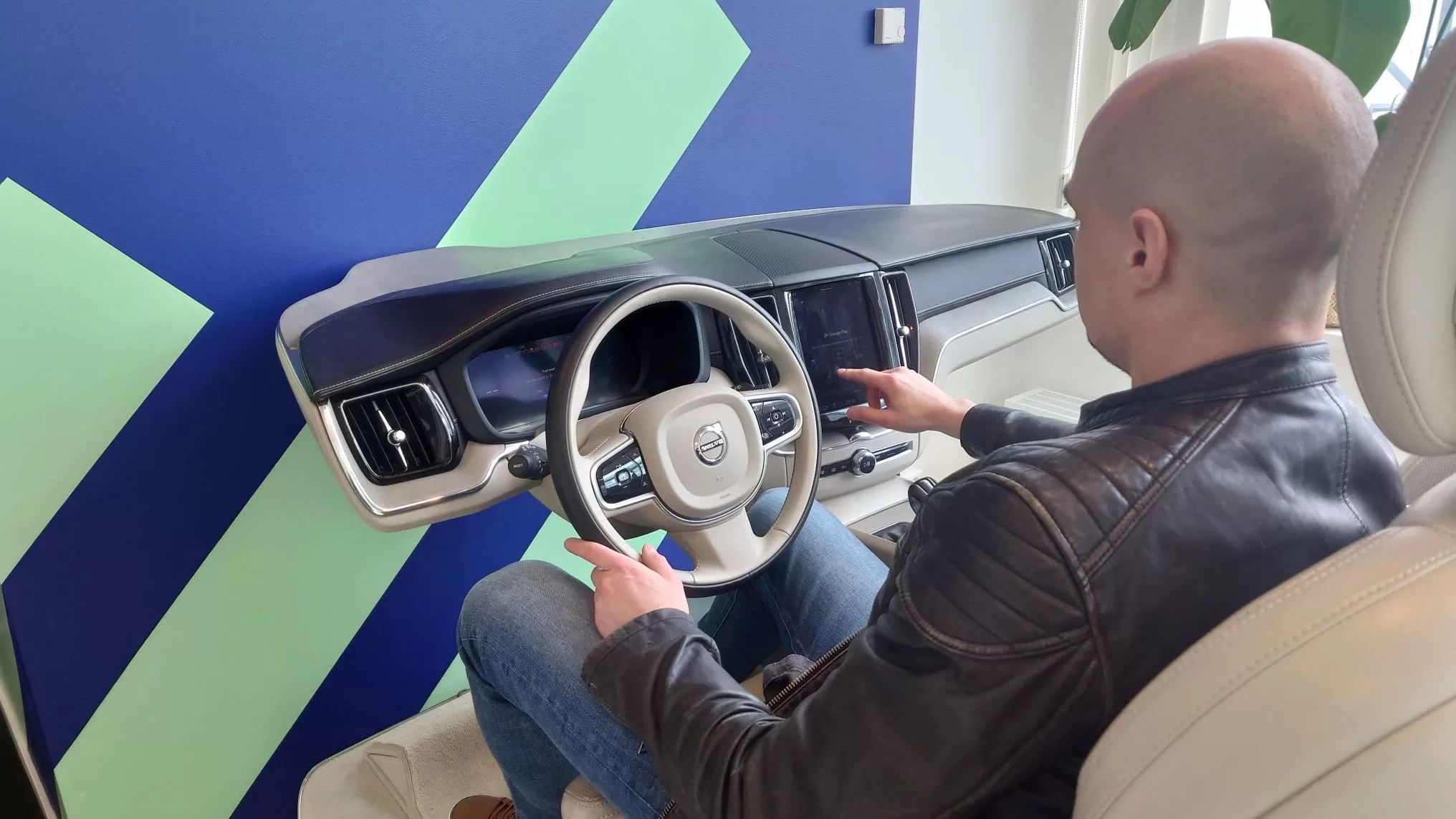 Profilence CEO Sami Utriainen tries out Volvo's infotainment setup developed by Haleytek, Volvo's Tier One infotainment system supplier and one of Profilence customers.