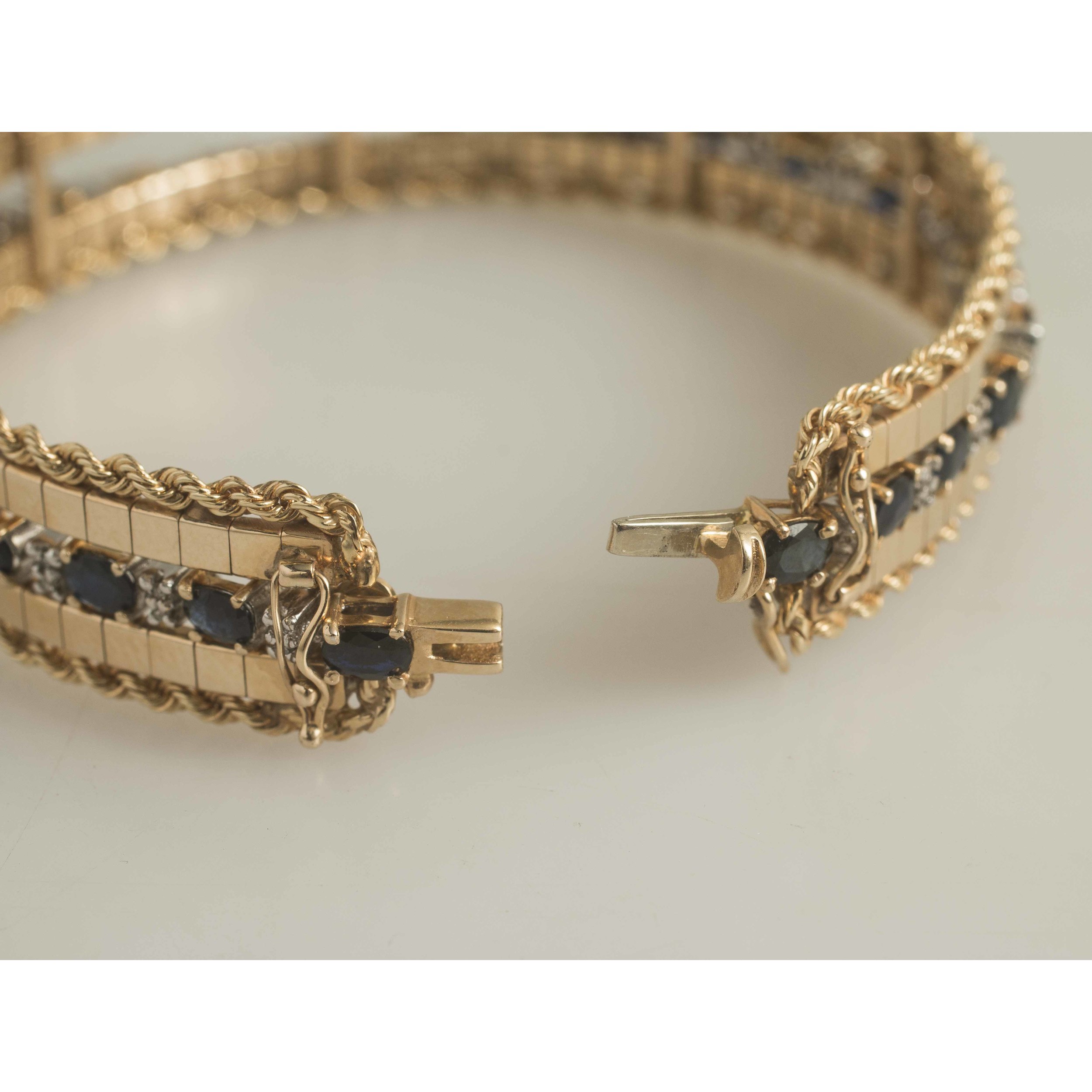 Unknown defects can turn into . Sapphire Diamond Bracelet & 14k Gold Jacket | Witherell's