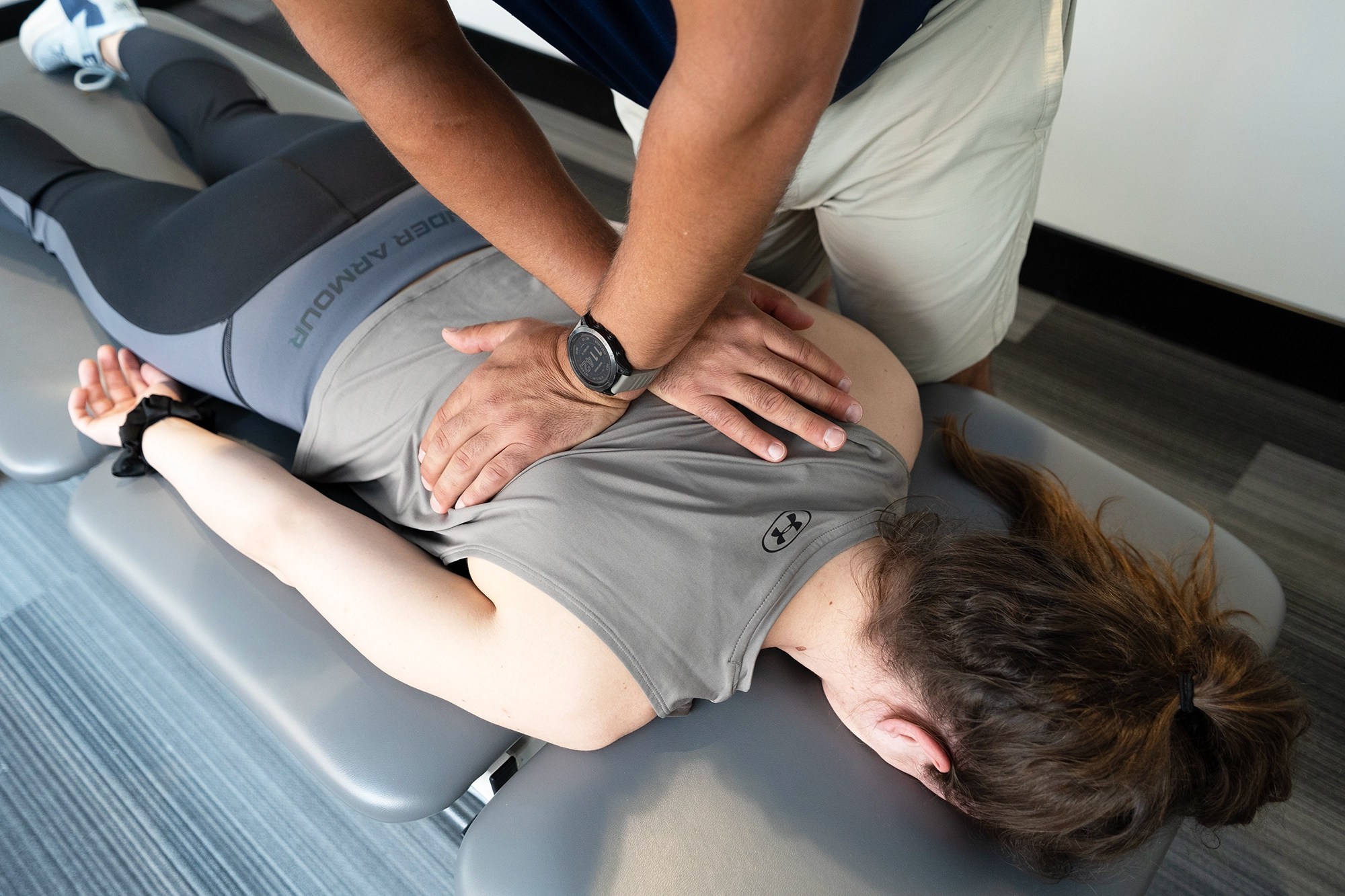 Physical therapist performing spinal manipulation for back pain