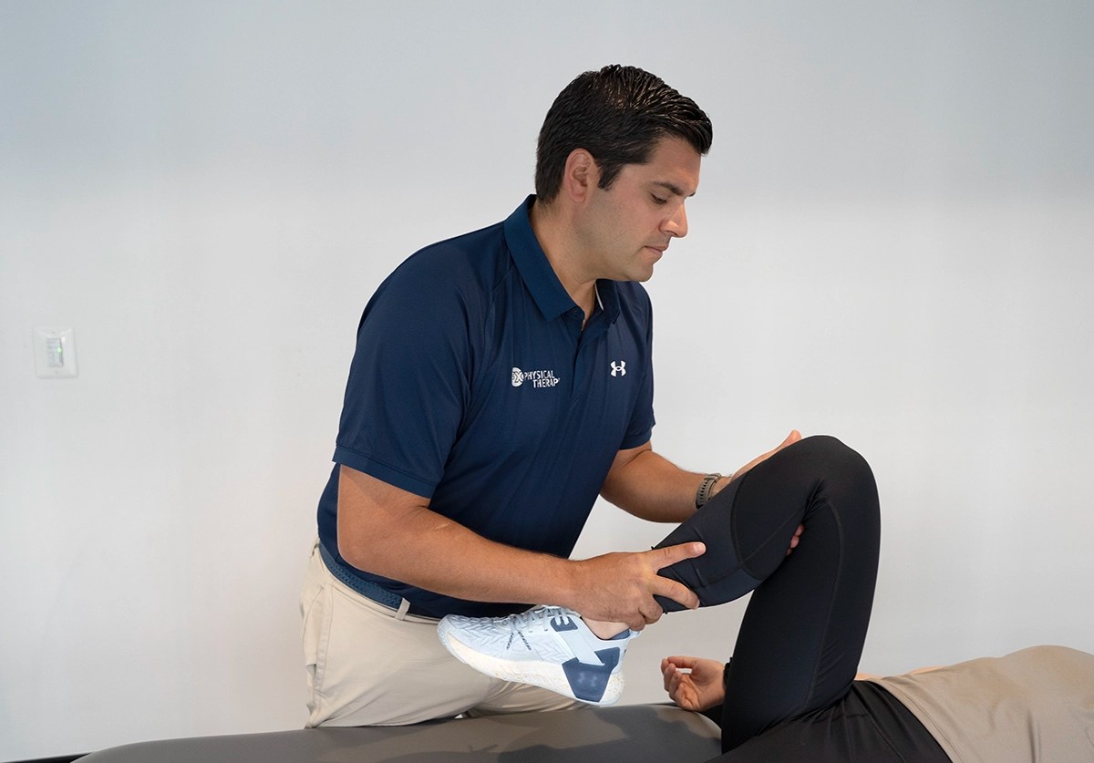 Physical therapist performing manual therapy on a patient's knee