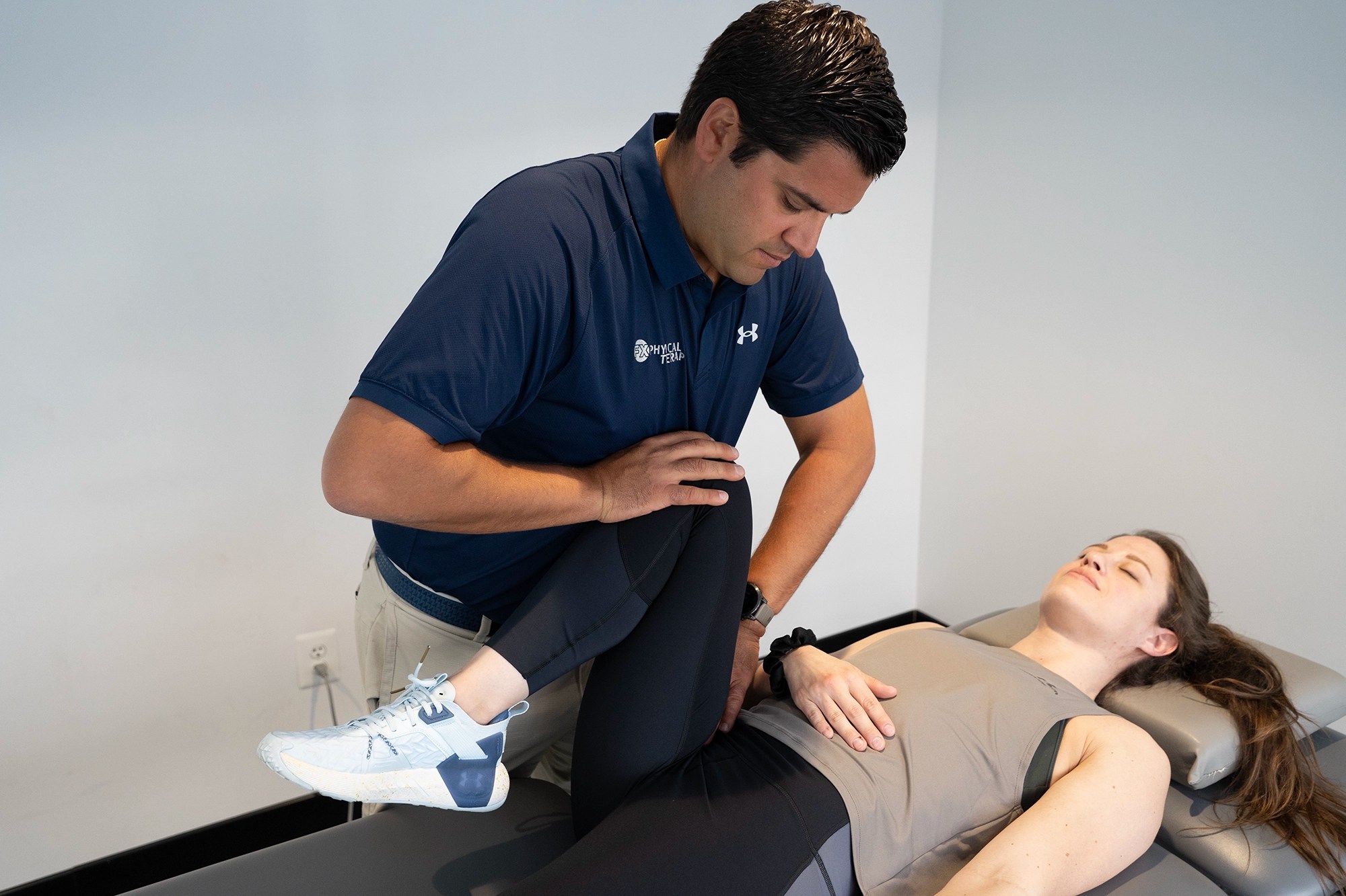Physical therapist performing manual therapy on a patient's knee