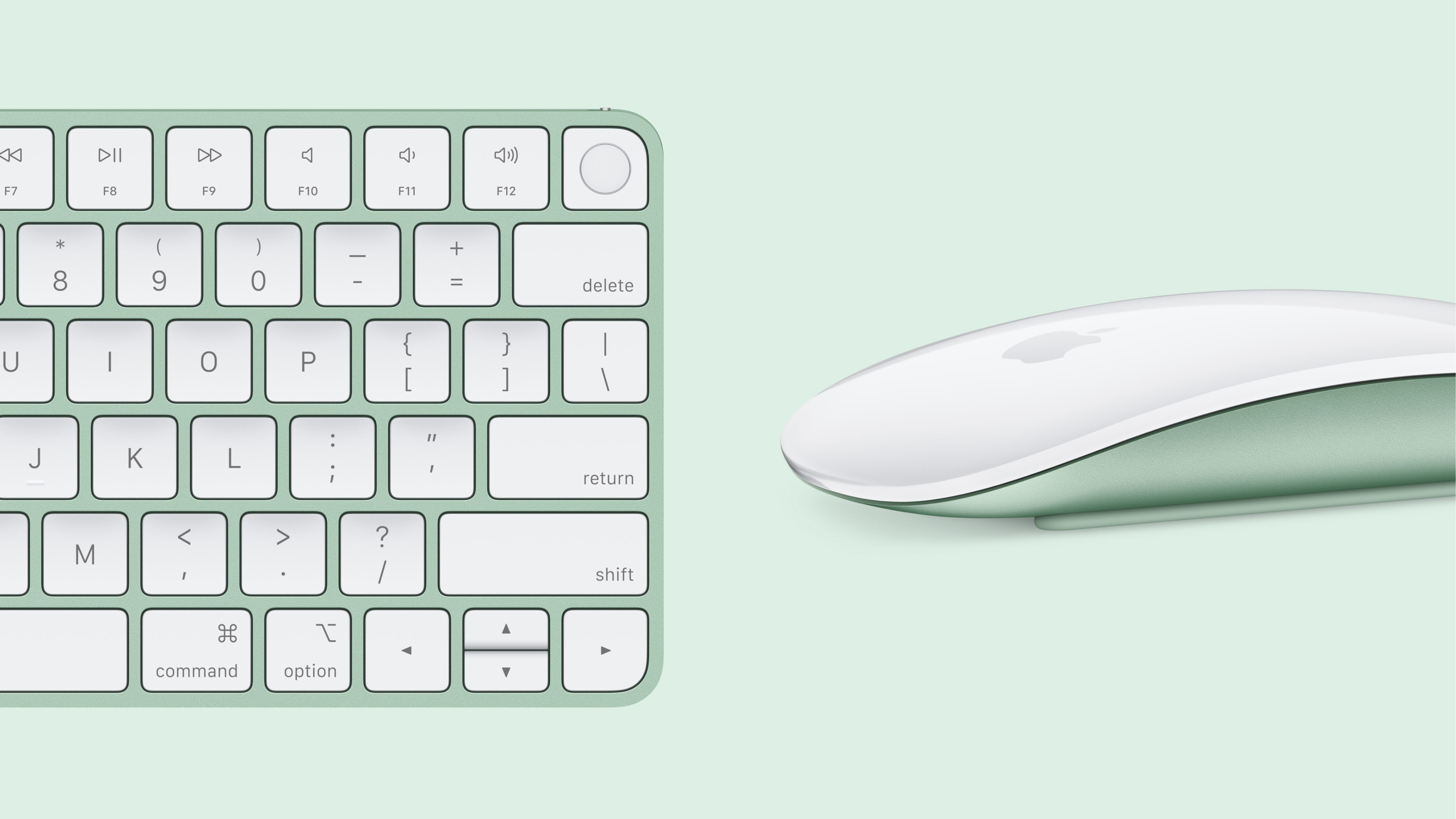 A white 2024 Apple Magic Keyboard and Magic Mouse in a light green color rest on a matching light green background. The keyboard has a compact design with a number pad on the right side. The mouse has a smooth, curved shape with a visible Apple logo.
