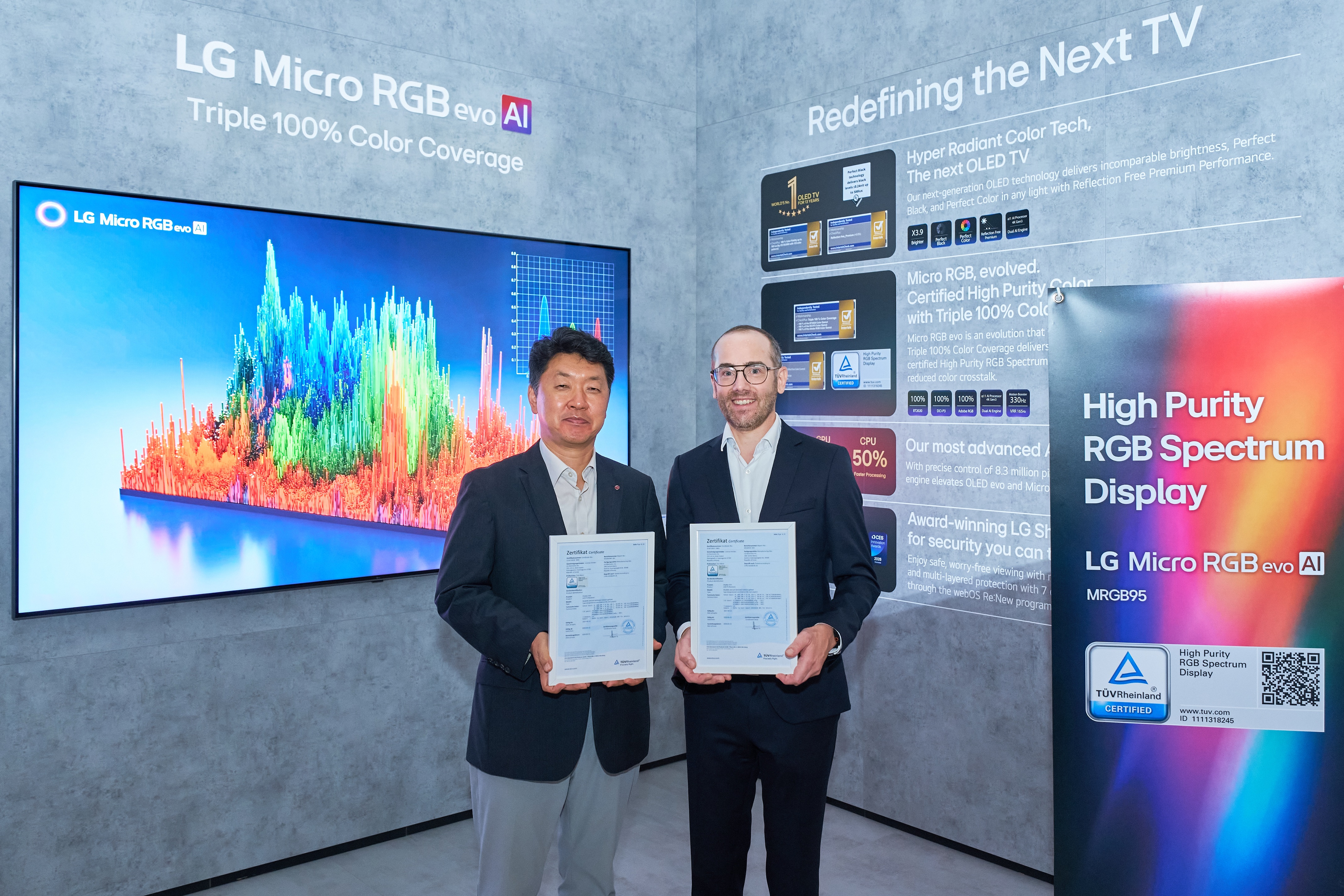 LG Micro RGB evo TV displayed at IFA 2026 with two representatives holding TÜV Rheinland certification documents for high-purity RGB spectrum display technology.