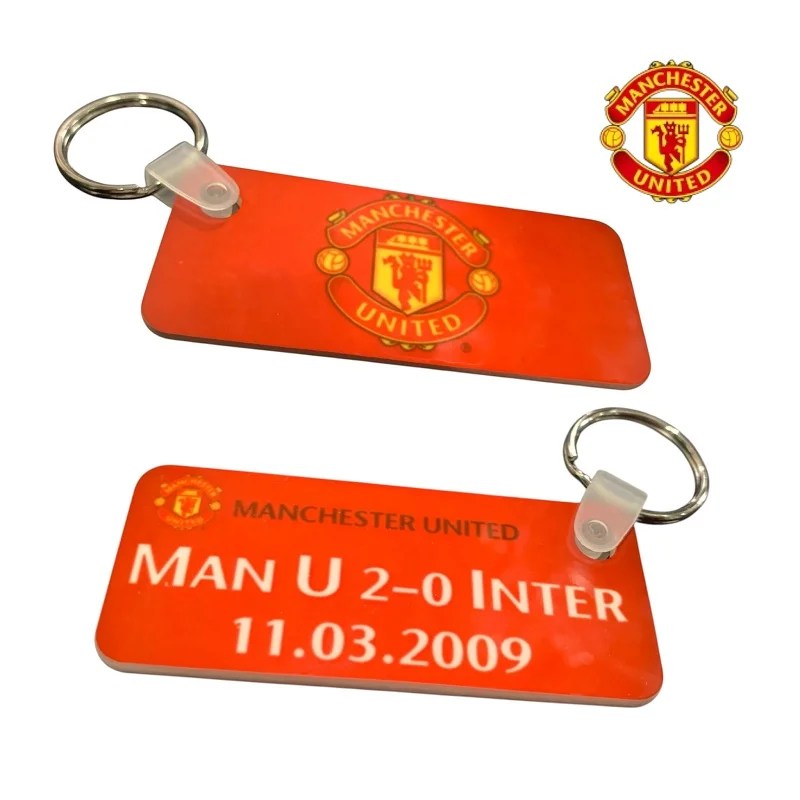 Official licensed Manchester United FC double-sided rectangular keychain featuring the club crest on one side and a commemorative match detail ("MAN U 2-0 INTER 11.03.2009") On The Reverse