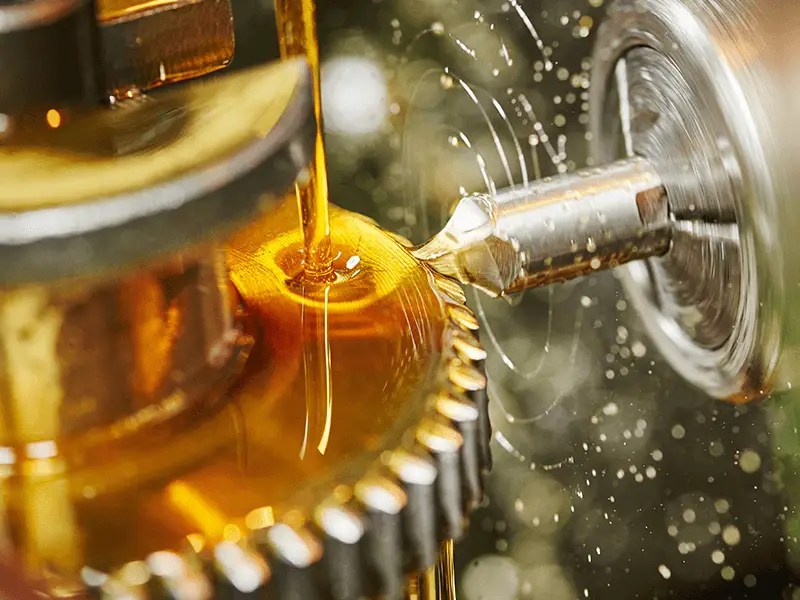 Industrial lubricant being applied to metal gear during machining process