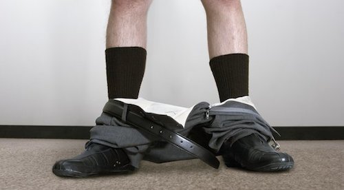 Businessman with pants around ankles