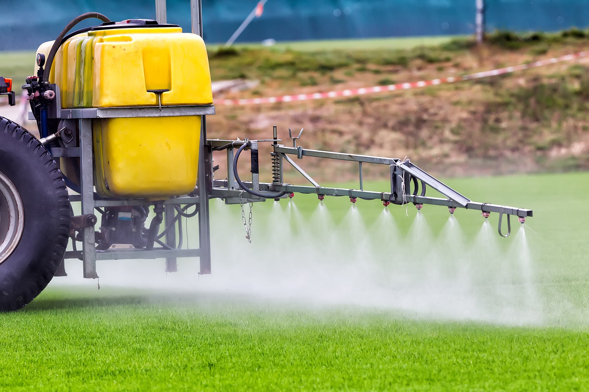Tractors sprayed with fertilizer grass on the pitch