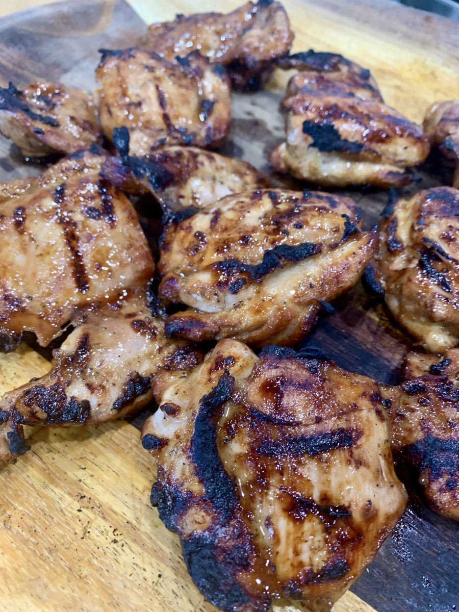 Basic Marinade for Grilling - Grilled marinaded chicken thighs on a wooden platter.