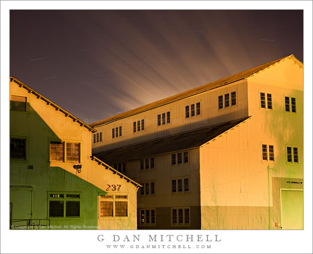 Yellow Buildings, Shadows, Moving Clouds - Night photograph of two large yellow buildings, shadows, and streaks for clouds moving across the sky above the Mare Island Naval Ship Yard, California.