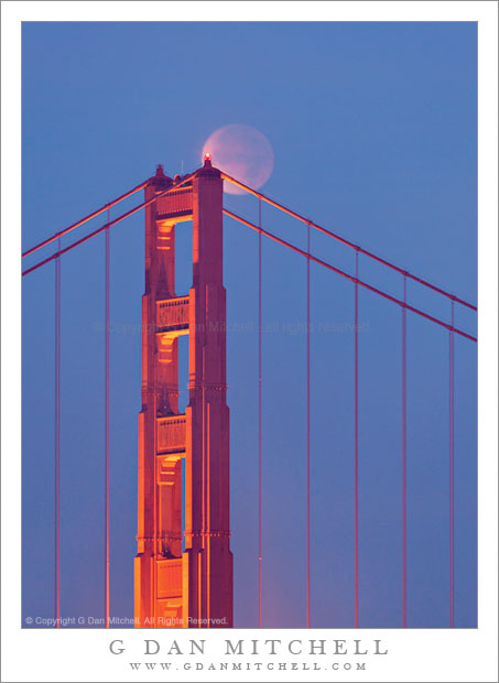 Golden Gate Bridge and Lunar Eclipse - The moon, in full lunar eclipse, passes behind the south tower of the Golden Gate Bridge.