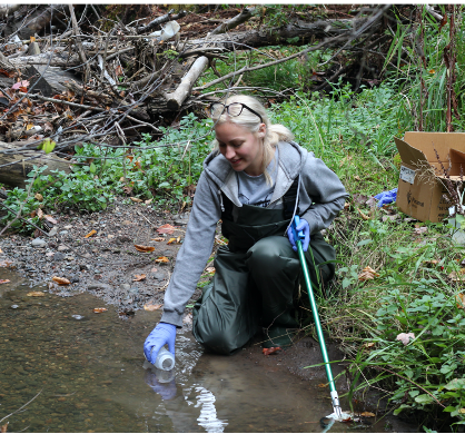 a student collecting a water sample