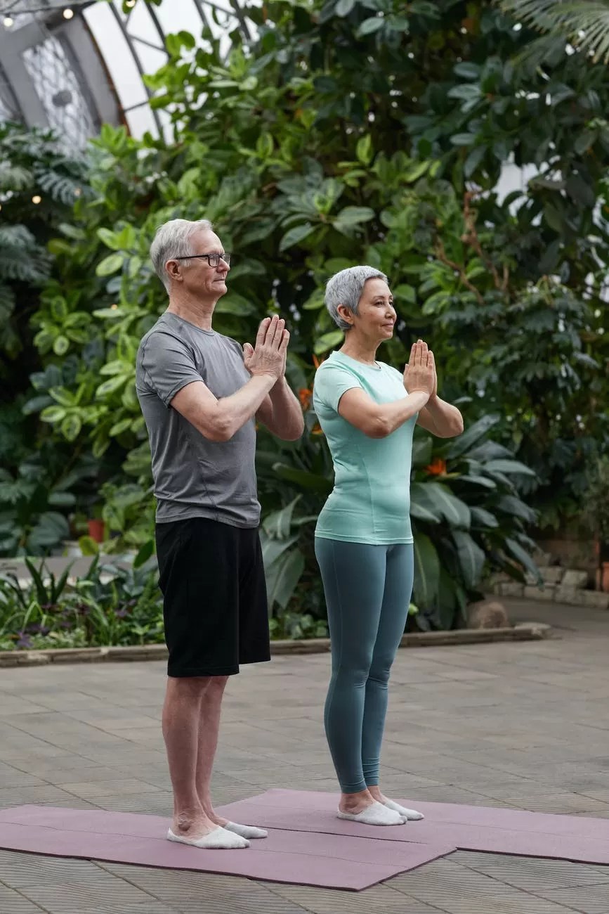 baby boomer couple practicing yoga