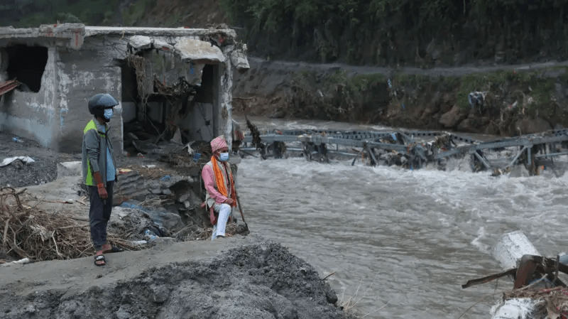 Men view the destruction after the flash floods and mudslide, at Devighat, Nuwakot district, Nepal,Image source,Reuters