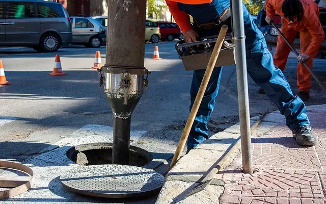 Sewer drain cleaning equipment in use