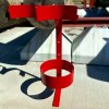 Metal holder for rubber insulating blanket canisters, designed to maximize truck belly compartment and deck storage space.