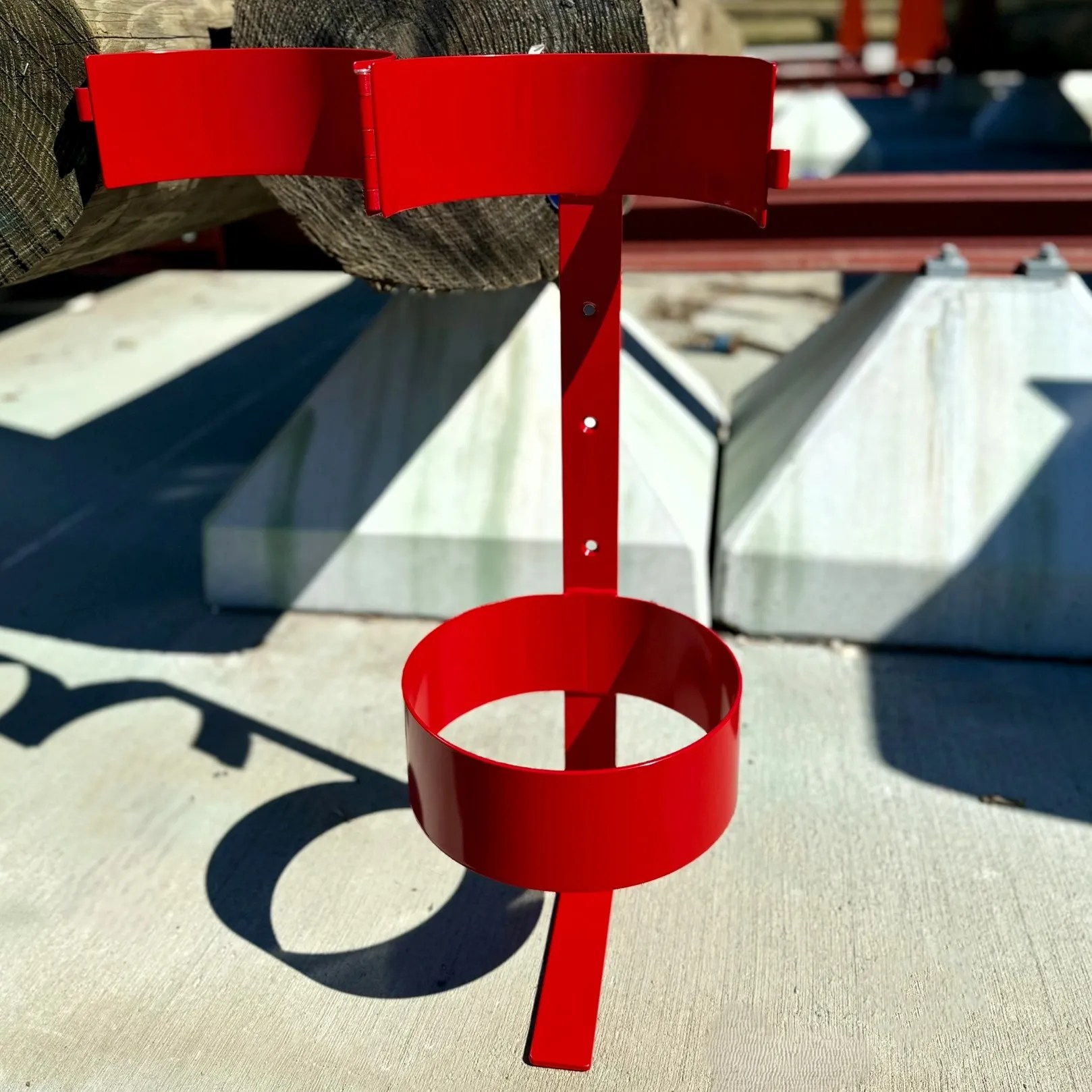 Metal holder for rubber insulating blanket canisters, designed to maximize truck belly compartment and deck storage space.