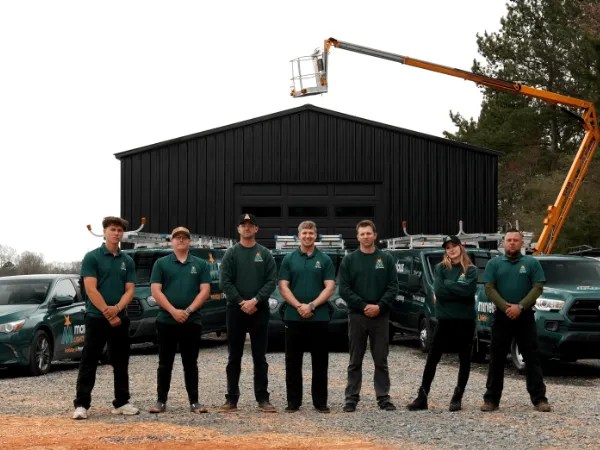 Marvelous Lights team prepares equipment outside a large building with vans