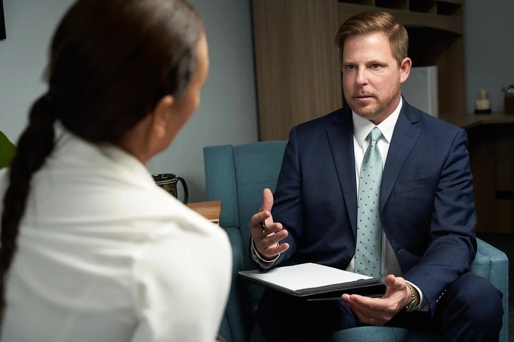 Attorney Gary Celetti speaking with someone across a consultation table