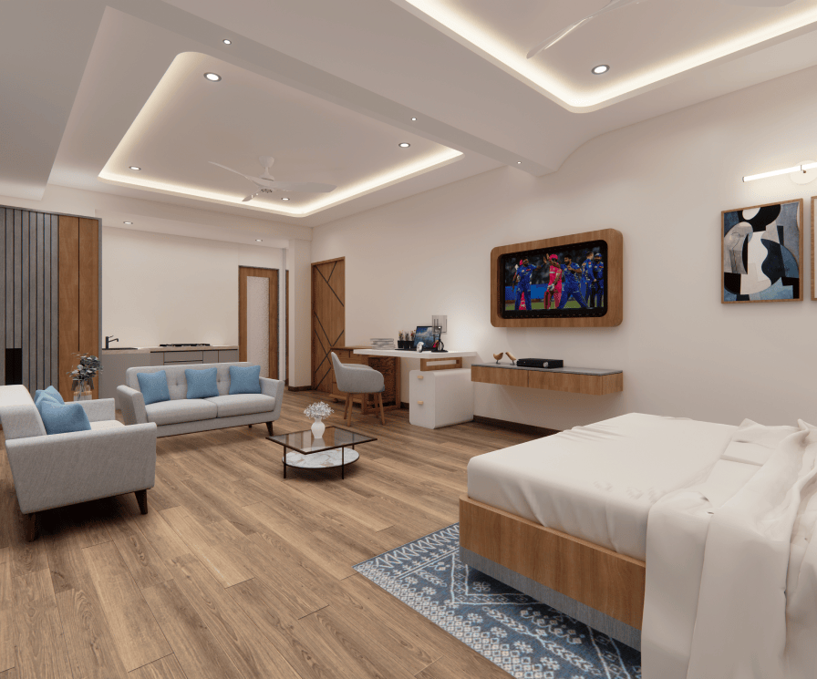 Side view of a fully furnished studio apartment with bed, sofa, TV unit, and study table at GHD Orchid Homes near Goa.