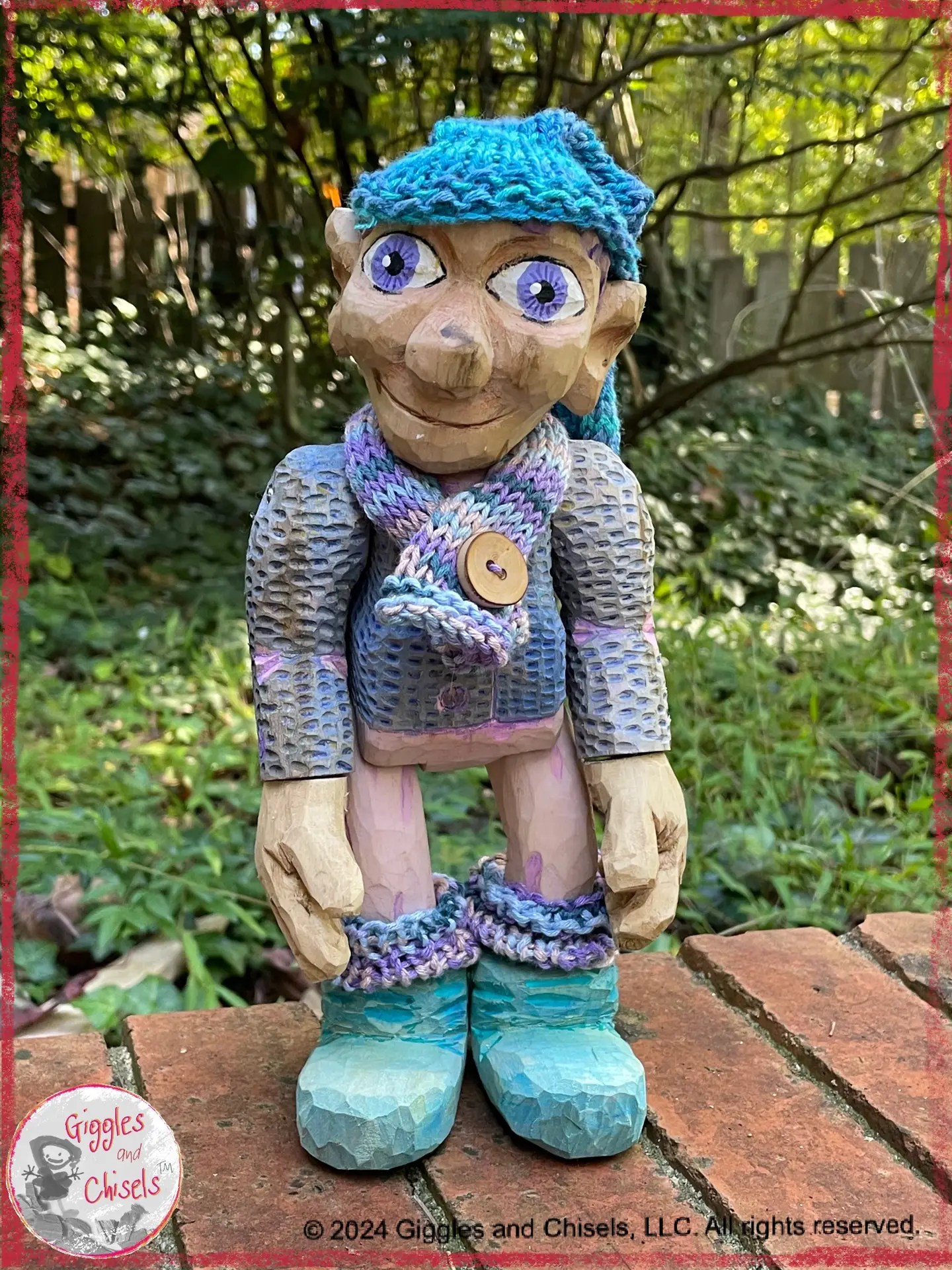 Petite Clothilde, a wooden puppet in blue, pink and purple tones.