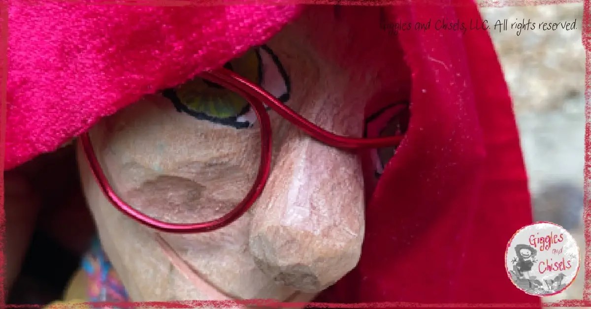 Mme Rigolotte, a wooden puppet, with a red cloth on her head