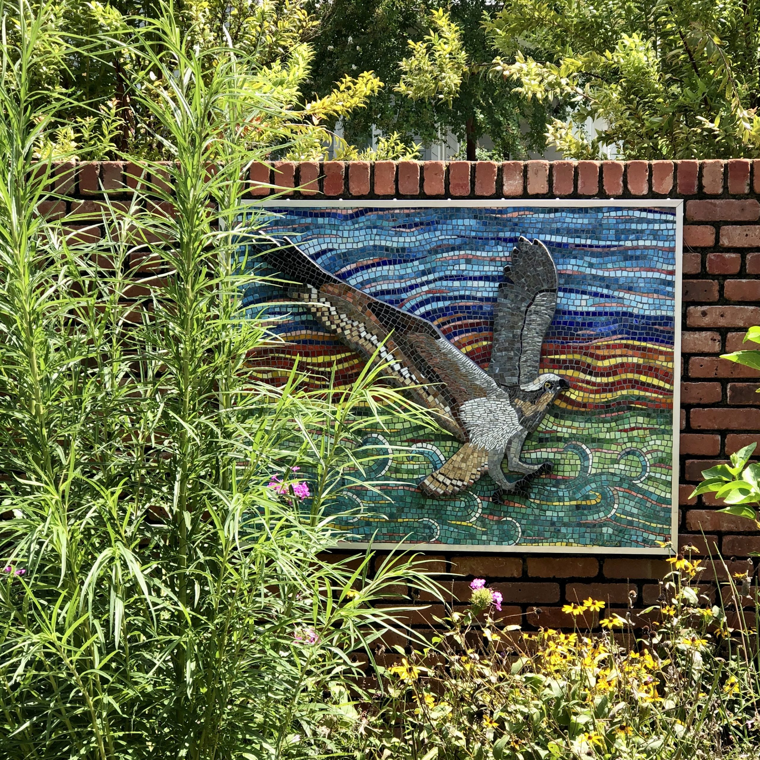 Osprey mosaic in the garden for which it was commissioned, in the overgrown summer