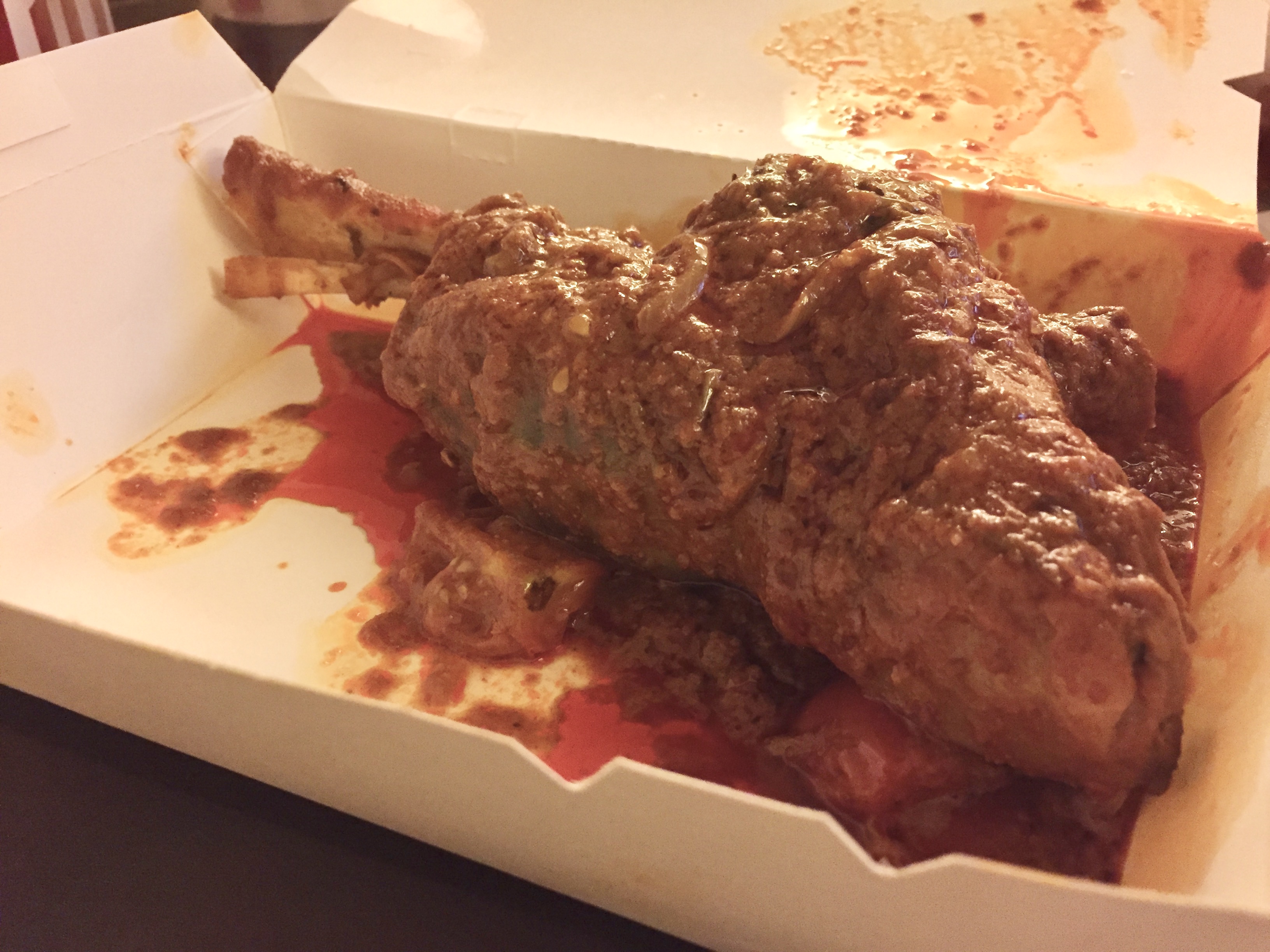 Lamb shank in orangish gravy.