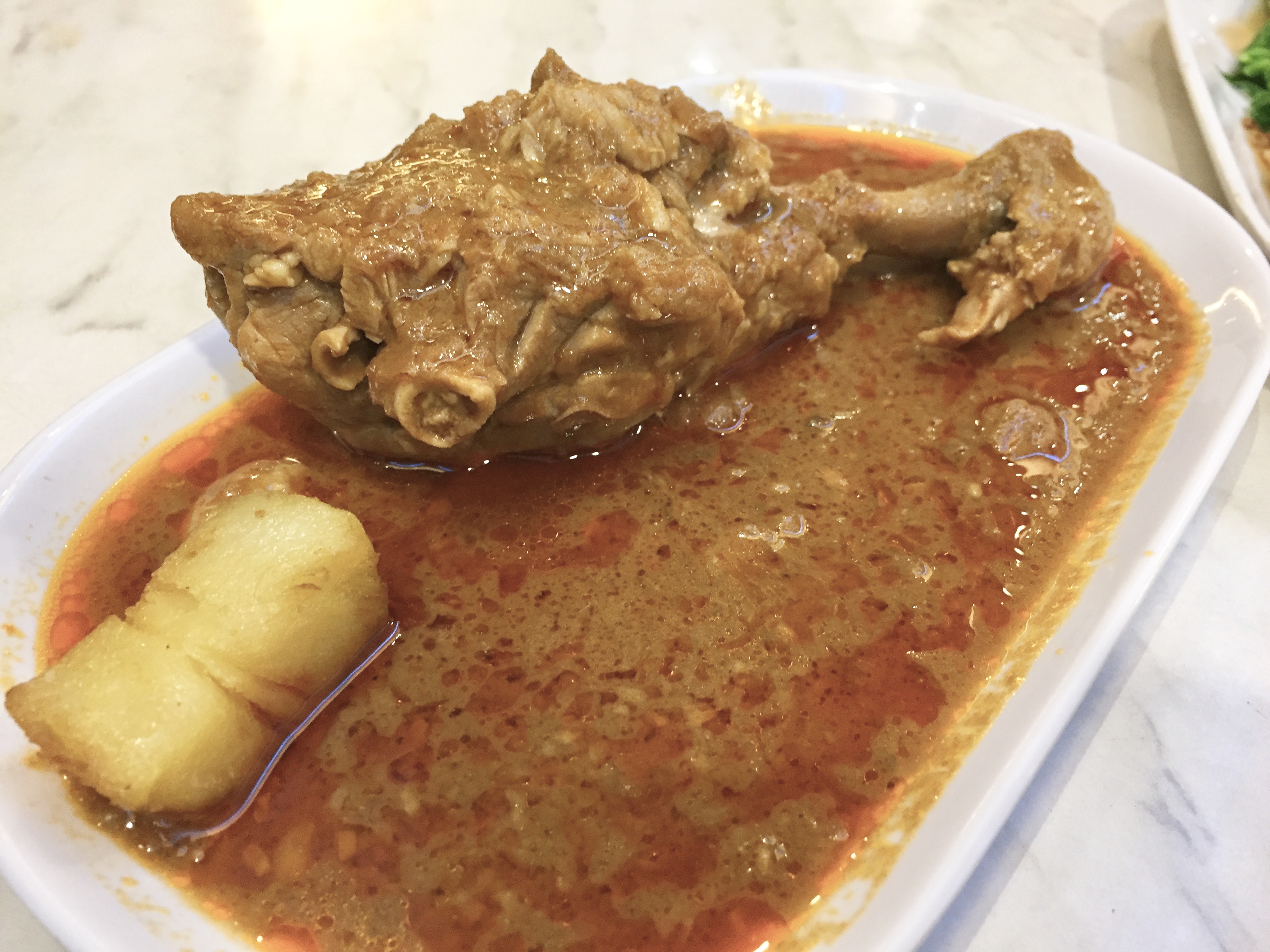 The combo constituted this chicken leg in an orangish gravy.