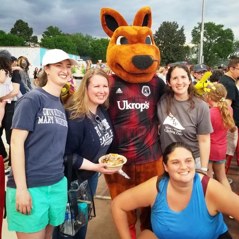 A group of four people and a kangaroo mascot.