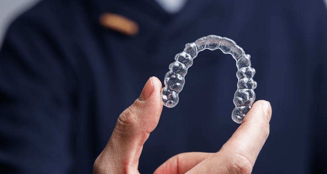 Dentist showing invisible aligner