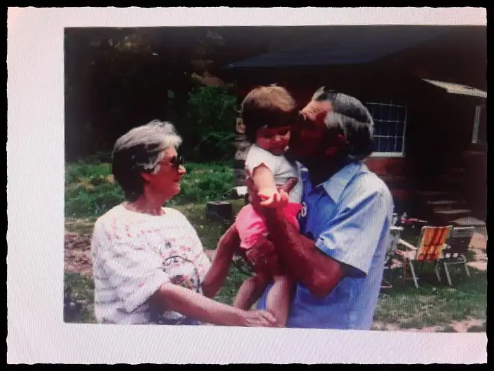 A man and woman loving care for a small child.