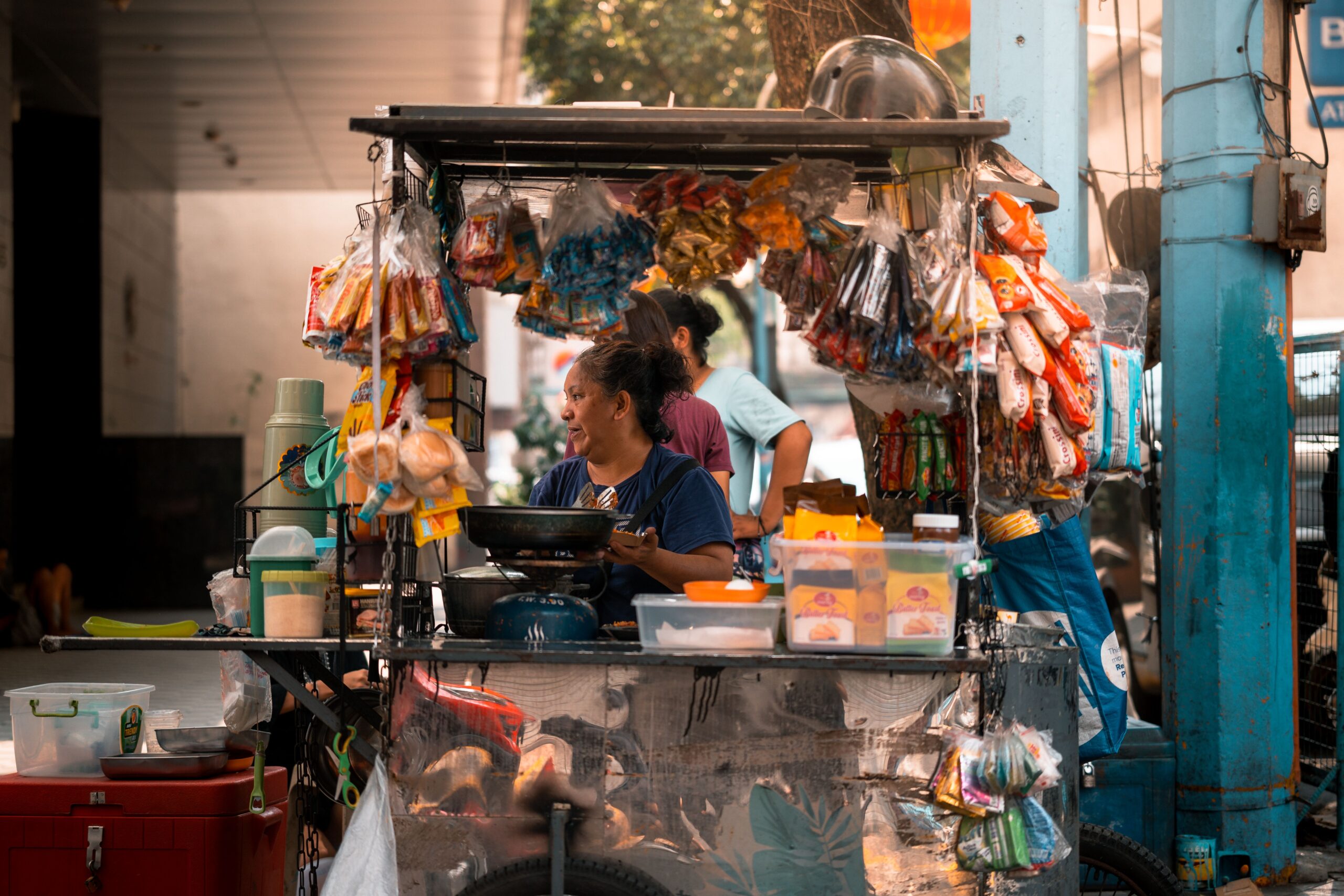Picture of street vendor in Southeast Asia manning her street food stall