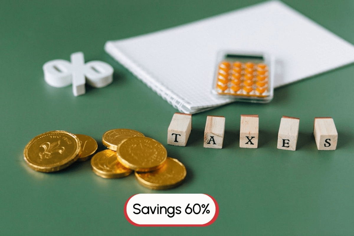 Various accounting items on green desks which include blocks that spell taxes, gold coins and mini calculator