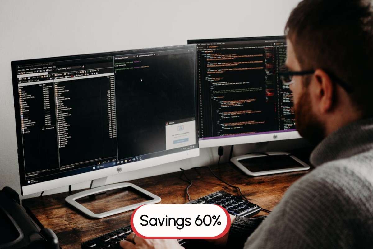 A web developer looking at two screens with code