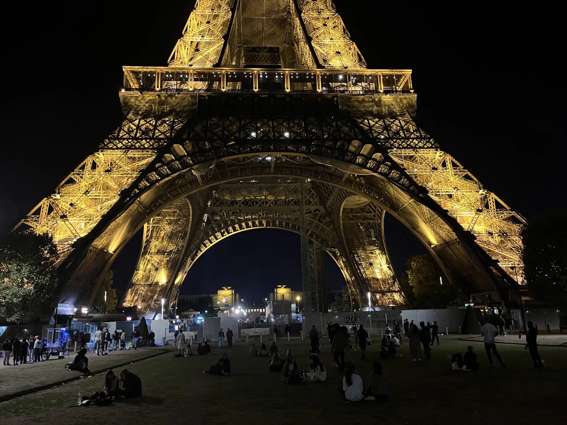 A night view of the bottom of the Eiffel Tower. 