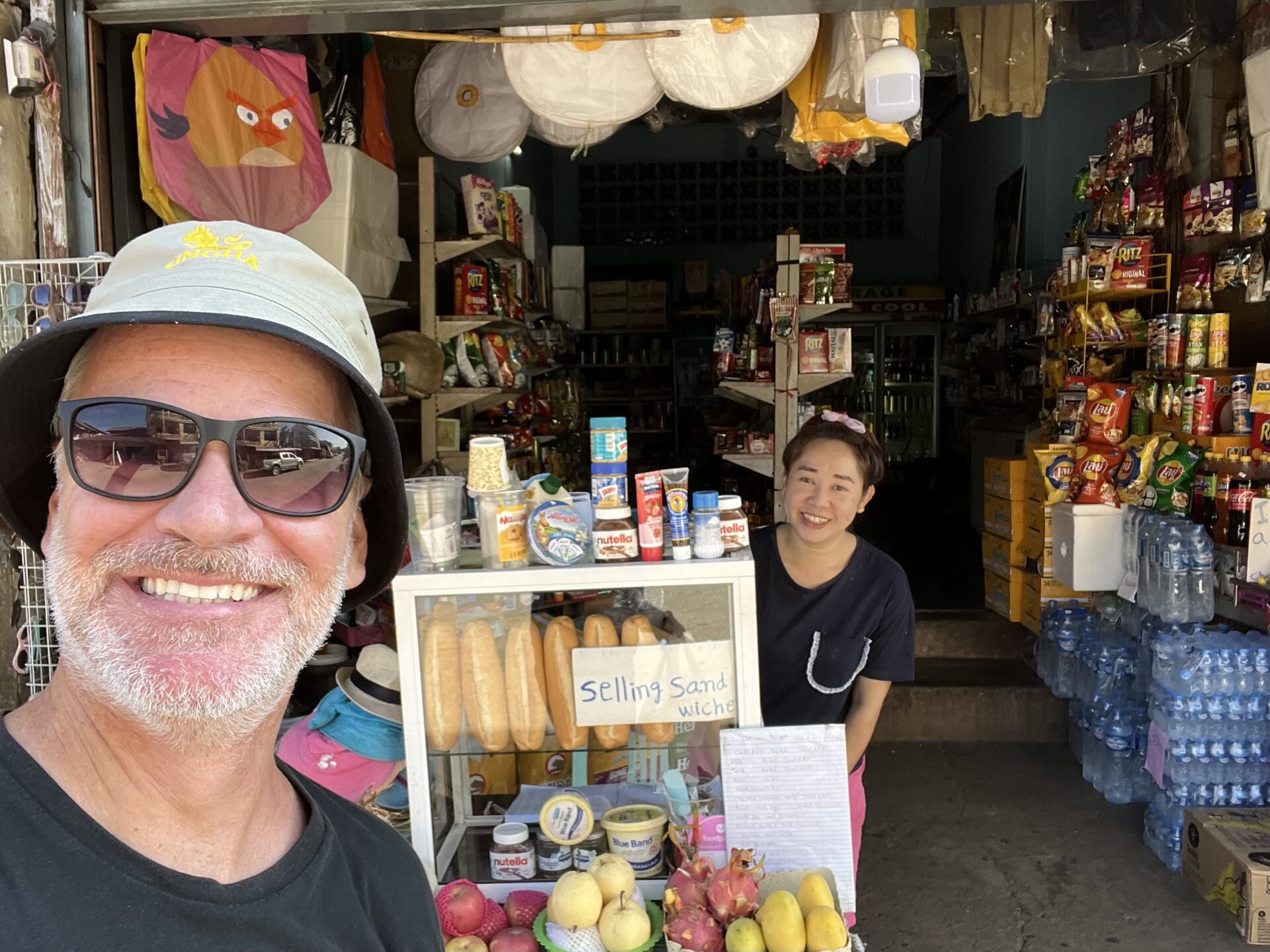 With the shop owner who sold me a cooler with lunch, a few beers, water and some snacks for my slow boat journey up the Mekong. 