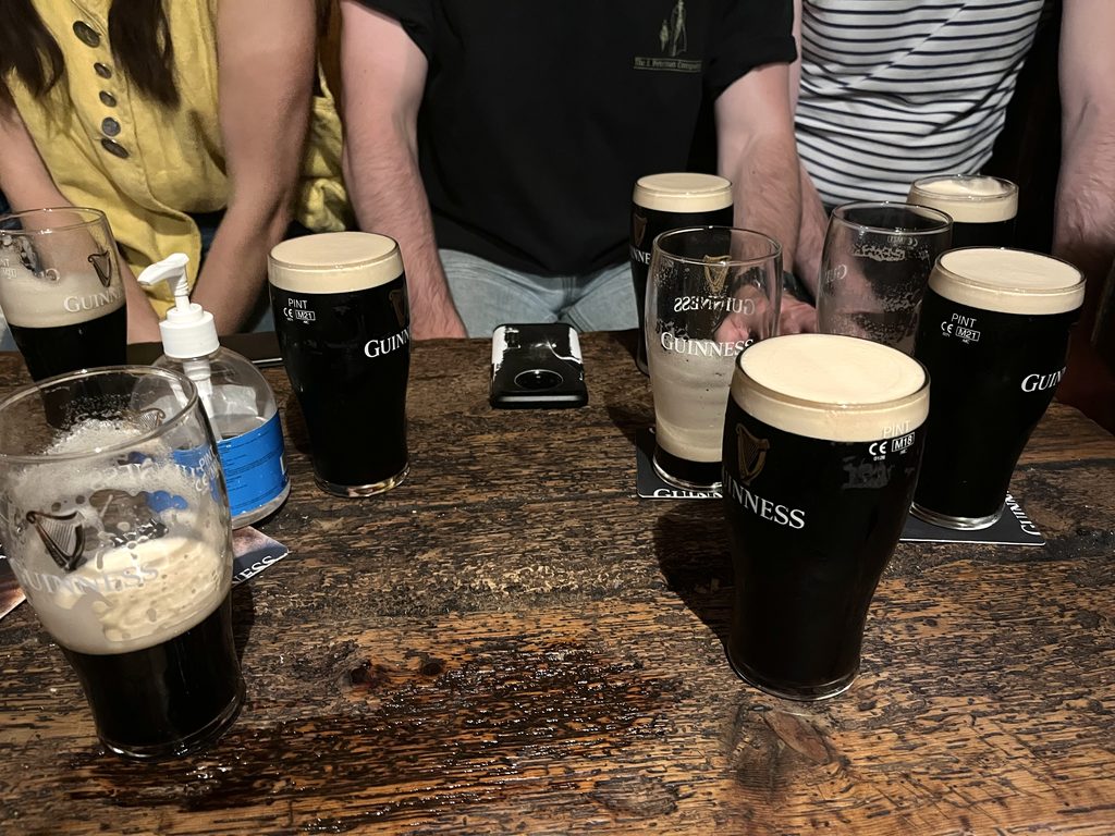 A table full of glasses of Guinness at Gravediggers