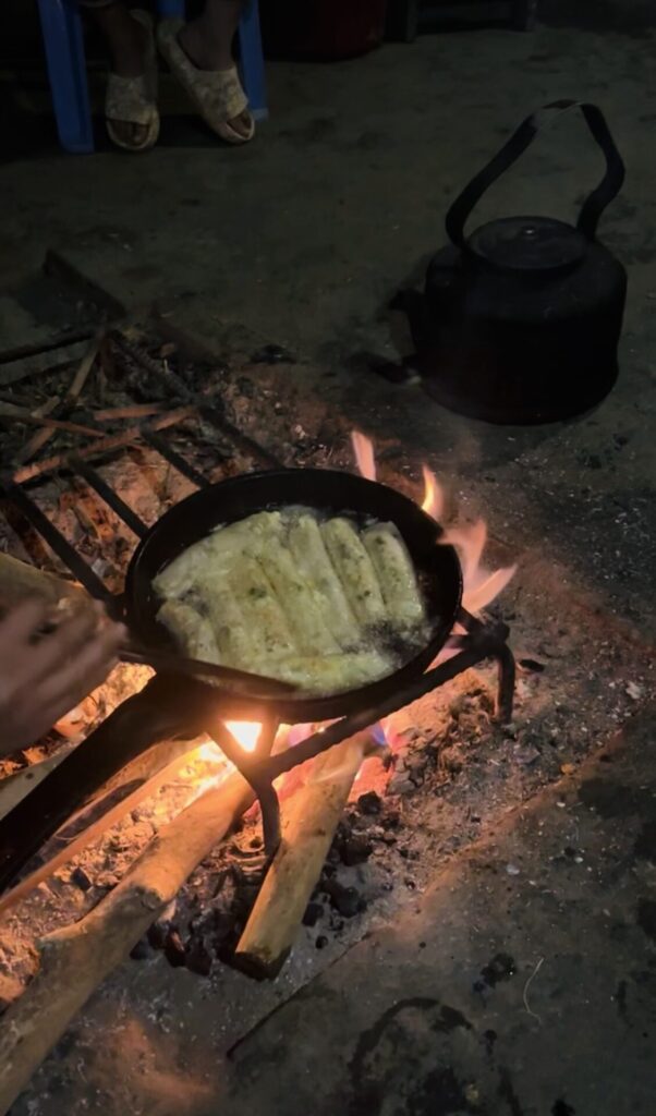 Cooking spring rolls on the open fire in the living room