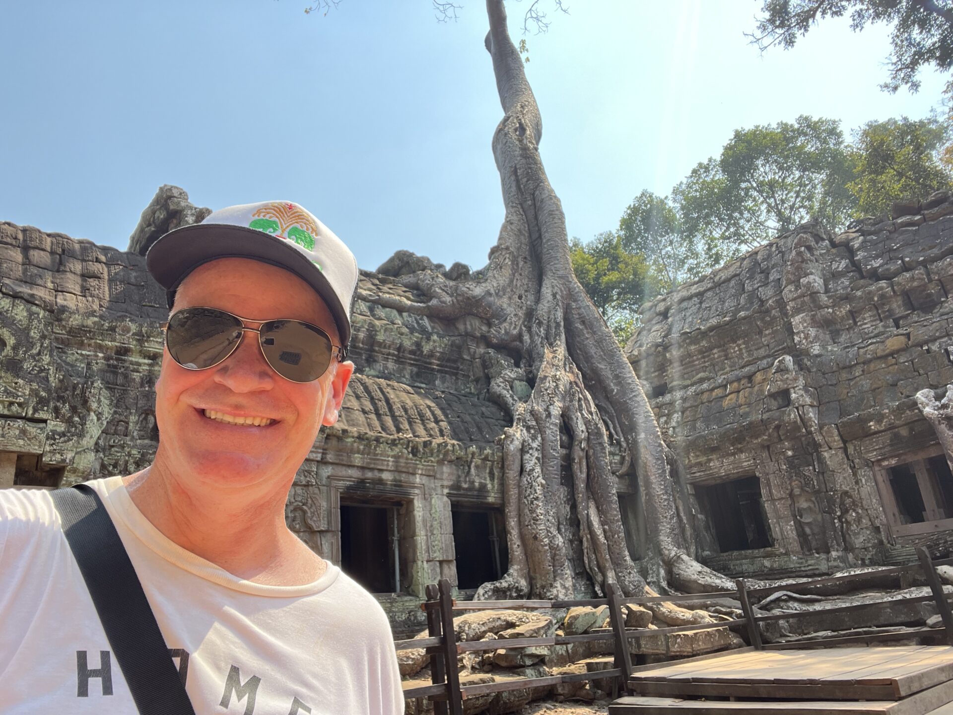 Ta Prohm temple, famous for its massive tree roots that grow over and through the stone ruins.