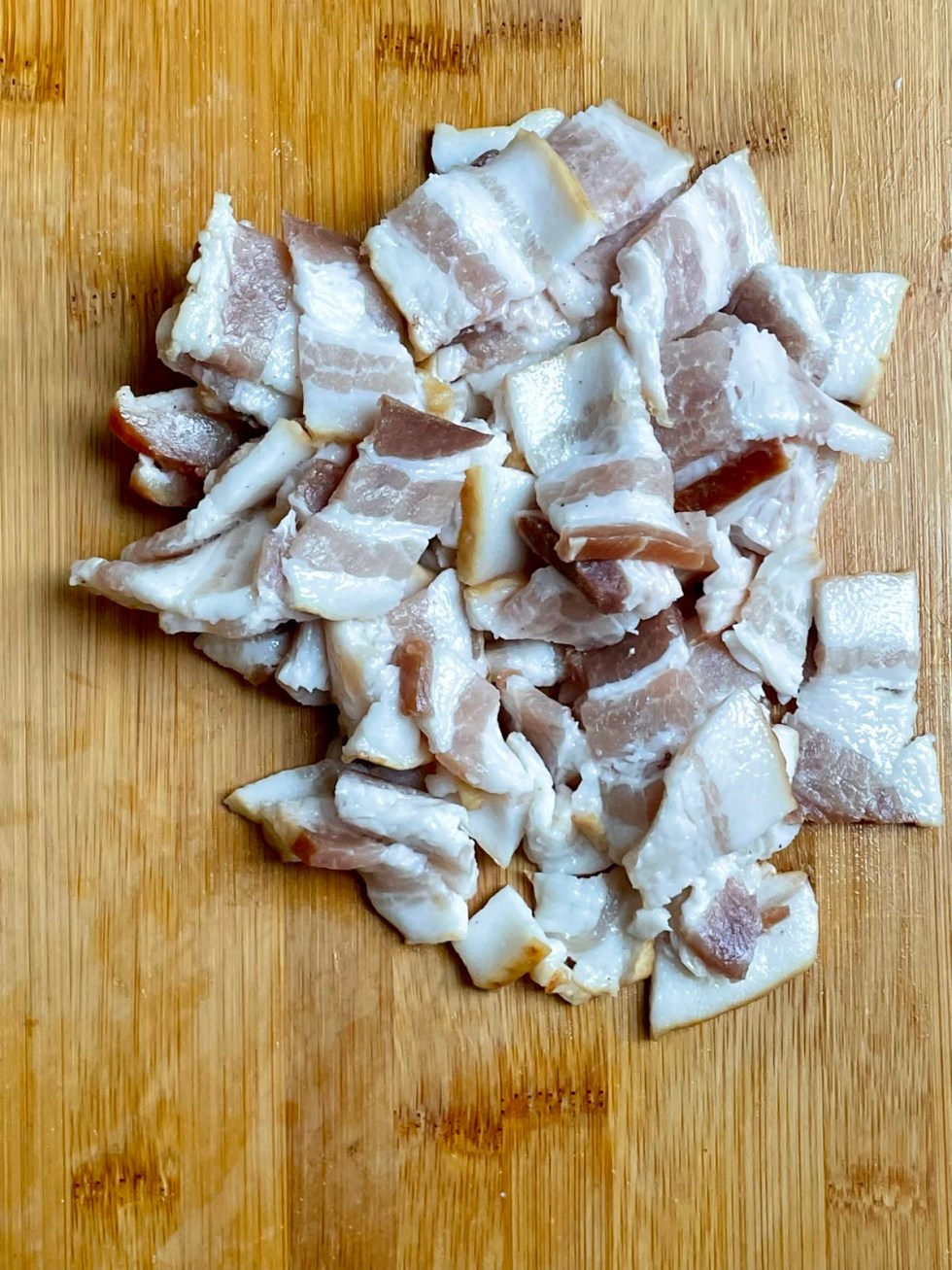 bacon cut-up on a cutting board