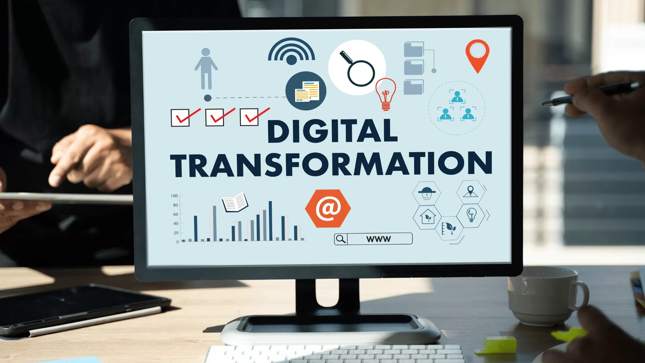 Computer screen showing digital transformation text with technology and data icons